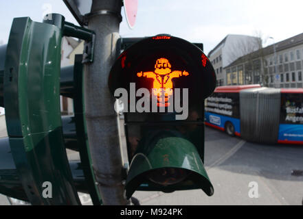 19 March 2018, Germany, Trier: A Karl Marx figure shines on the traffic light. LED technology and stencils were installed for the traffic light close to the soon to be erected Karl Marx statue. Photo: Harald Tittel/dpa