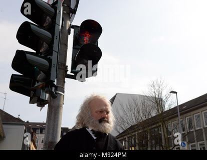 19 March 2018, Germany, Trier: A Karl Marx figure stands underneath a traffic light with a red Karl Marx symbol. LED technology and stencils were installed for the traffic light close to the soon to be erected Karl Marx statue. Photo: Harald Tittel/dpa