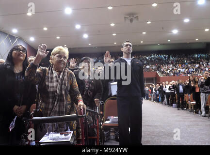 San Diego, CA, USA. 21st Mar, 2018. Hundreds of new citizens were naturalized at Golden Hall a venue in downtown San Diego. US Navy Seaman Ievgen Kozakov, from the Ukraine, right, raises his hand as he is sworn in as a citizen of the United States. He is based aboard the USS Boxer. Credit: John Gastaldo/ZUMA Wire/Alamy Live News Stock Photo
