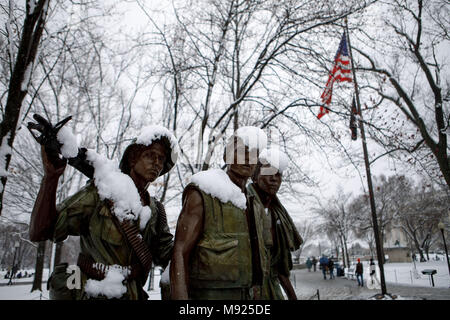 (180321) -- WASHINGTON, March 21, 2018 (Xinhua) -- The Three Servicemen statue is covered with snow in Washington, DC, the United States, on March 21, 2018. A late-season nor'easter, the fourth of its kind in three weeks, is targeting the northeast United States on Wednesday, bringing heavy snow and strong winds to the region. Washington, which is already snow-covered, is expected to see up to 6 inches of snow, as some models suggesting much high totals for the capital. Federal offices are closed for the snowstorm as the White House announced early Wednesday that all public events for the day Stock Photo