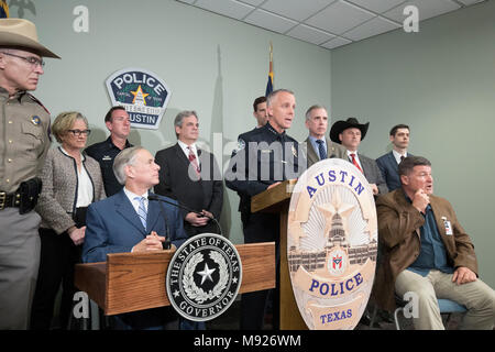 Austin interim Police Chief Brian Manley leads a congratulatory press conference with Texas Gov. Greg Abbott (seated at left) and others who assisted in finding alleged Austin serial bomber, Mark A. Conditt. Conditt killed himself as police closed in on him on March 21. Stock Photo
