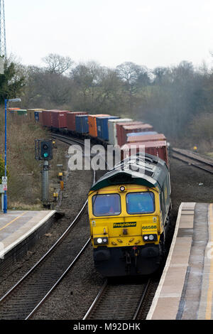 A class 66 diesel locomotive pulling a freightliner train through Hatton station, Warwickshire, UK Stock Photo