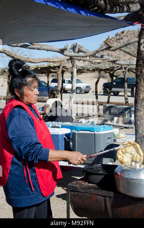 A Tohono O'odham Indian woman makes Indian fry bread for tourists visiting San Xavier del Bac Mission near Tucson, Arizona. Stock Photo