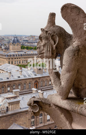 Gargoyle overlooking city of Paris from Cathedral Notre Dame tower, Paris, Ile-de-France, France Stock Photo