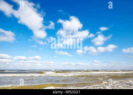 Blue sky with clouds over a sea. Stock Photo