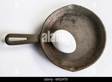 Whole egg in cast iron frying pan. Stock Photo