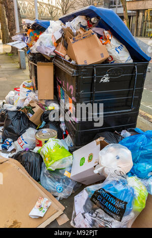 Piles of rubbish and discarded wate awaiting or waiting for collection on the side of the street. Rubbish and trash garbage abandoned in bags and bins Stock Photo