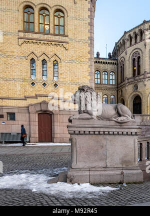 Oslo, Norway - march 16, 2018: Exterior of the Parliament of Norway in Oslo, Norway. The Lion Statue watching a lonely pedestrian. Stock Photo
