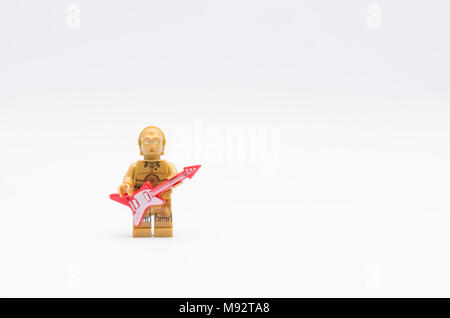 lego c3po minifigure holding a guitar with microphone, isolated on white background. Stock Photo