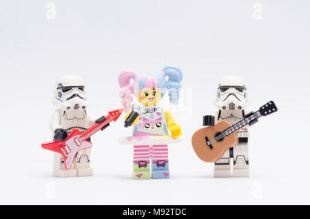 n-pop girl holding microphone singging with storm troopers play the guitar. isolated on white background. Stock Photo