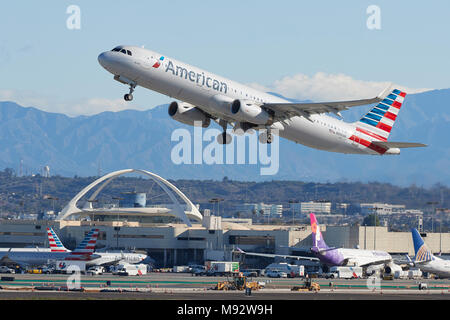 American Airlines Airbus A321 Jet Airliner Takes Off From Los Angeles International Airport, LAX. The Theme Building And San Gabriel Mountains Behind. Stock Photo