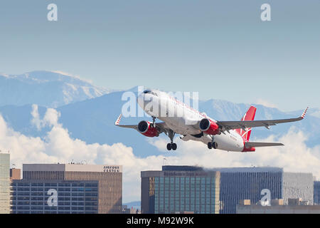 Virgin America Airbus A320 Jet Plane, Taking Off From Los Angeles International Airport, LAX, The Snow Covered San Gabriel Mountains Behind. Stock Photo