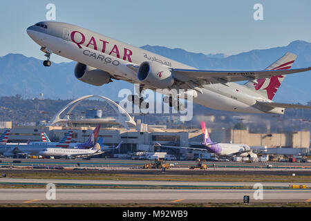 Qatar Airways Cargo Boeing 777 Cargo Jet Taking Off From Los Angeles International Airport, LAX. The San Gabriel Mountains In Background. Stock Photo
