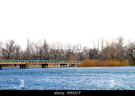 image of a pedestrian bridge across a large river Stock Photo