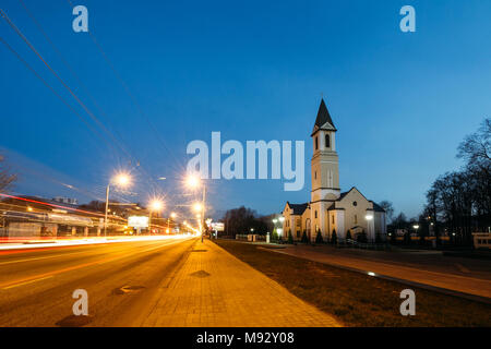 Catholic church of the Roman Catholic Church in Sovetskaya Street in the city of Gomel at night with the road and traffic on it Stock Photo