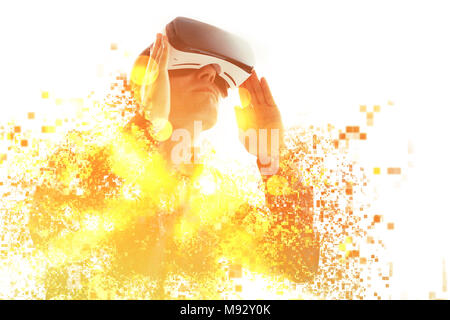 A person in virtual glasses flies to pixels. The man with glasses of virtual reality. Future technology concept. Modern imaging technology. Fragmented Stock Photo