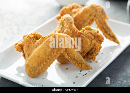 Fried chicken wings on a white plate Stock Photo