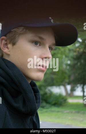 Profile portrait of a young teen wearing a baseball cap. Minneapolis Minnesota MN USA Stock Photo