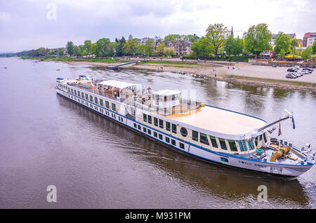 The river cruise ship MS Swiss Ruby goes down the Elbe River and passes the Schiller garden in Dresden-Blasewitz, Dresden, Saxony, Germany. Stock Photo