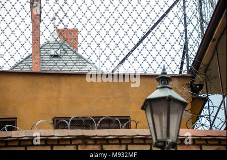 Security measures around a detention centre building in Torun, Poland. Razor wire, high wall, rooftop view Stock Photo