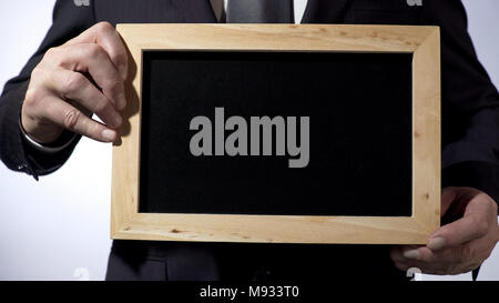 Blackboard template with empty space for your text, businessman holding sign Stock Photo