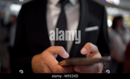 Closeup of male hands texting on smartphone, modern gadget, mobile communication Stock Photo