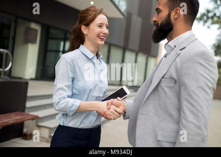 Business and office concept. Businessman and businesswoman shaking hands Stock Photo
