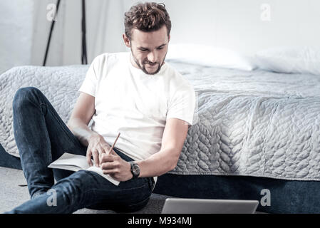 Nice handsome man holding a pencil Stock Photo