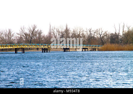 image of a pedestrian bridge across a large rive Stock Photo