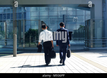 Two Japanese businessmen walking to office Stock Photo