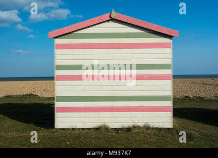 Colourful English seaside beach hut on the coast at New Romney, Kent, England, UK Stock Photo