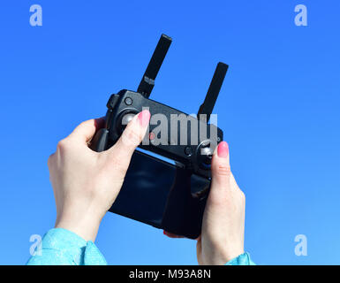 remote control for quadrocopter with smartphone in female hands Stock Photo