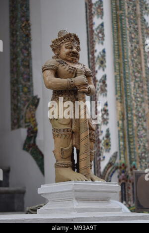 In Focus small ivory color statue in the front of the big palace in Bangkok Thailand. Stock Photo