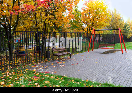 Autumn landscape bench and swing yellow leaves Stock Photo