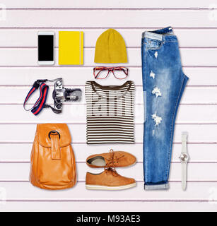 Still life of clothes, denim skirt with dungarees, striped shirt