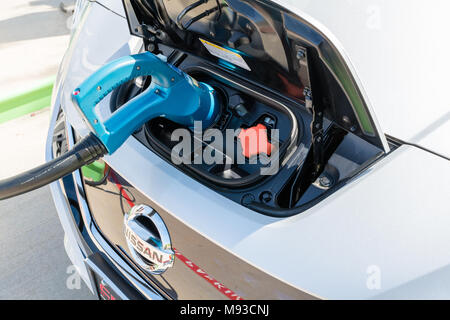 Pearland, Texas - March 21, 2018: New 2018 Nissan Leaf electric car plugged in to charge battery at the EVgo charging station Stock Photo