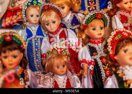 Hungarian dolls in embroidered lace national costume with floral motifs and patterned headdresses sold as souvenir merchandise in Budapest to tourists Stock Photo