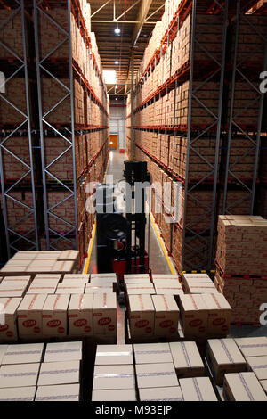 Klaten, Indonesia. 20th Mar, 2018. A worker moving boxes of milk using fork lift in ware house at milk processing plant owned by PT Sarihusada Generasi Mahardhika, a subsidiary of Danone Group at Kemudo, Klaten, Indonesia. It is one of the biggest Danone factory in Asia that produce growing up formula milk for children, with production capacity up to 100.000 tons per years. Credit: Dadang Trimulyanto/Pacific Press/Alamy Live News Stock Photo