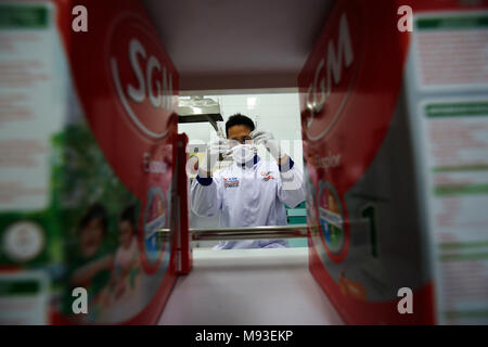 Klaten, Indonesia. 20th Mar, 2018. A worker inspects milk in laboratory at milk processing plant owned by PT Sarihusada Generasi Mahardhika, a subsidiary of Danone Group at Kemudo, Klaten, Indonesia. It is one of the biggest Danone factory in Asia that produce growing up formula milk for children, with production capacity up to 100.000 tons per years. Credit: Dadang Trimulyanto/Pacific Press/Alamy Live News Stock Photo