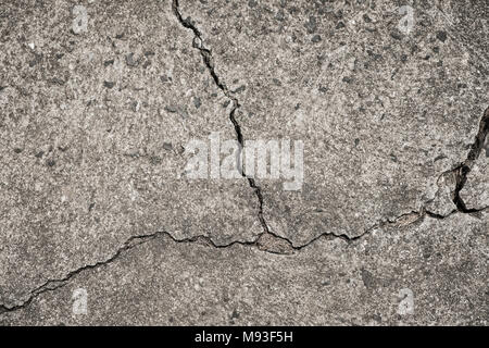 cracked concrete floor - crack in wall - broken stone texture Stock Photo