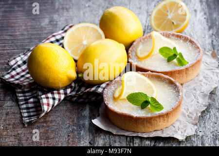 Mini  lemon tarts on wooden table Stock Photo