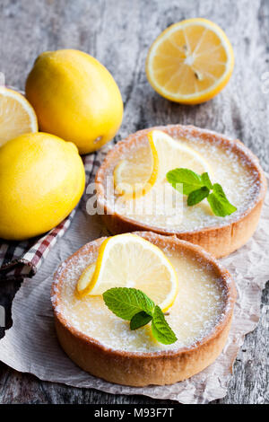 Mini  lemon tarts on wooden table Stock Photo