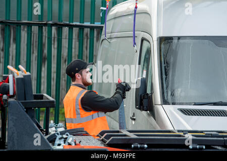 Wheel clamping of untaxed vehicles is becoming more common with the paper tax disc display being abolished and car tax needing to be paid online. Stock Photo