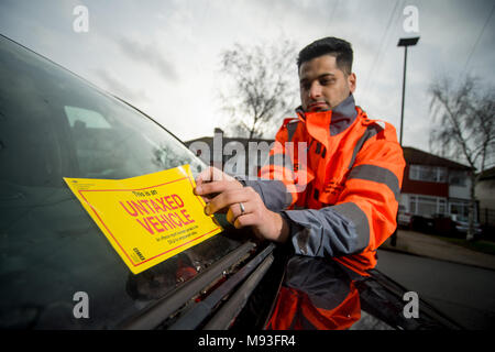 Wheel clamping of untaxed vehicles is becoming more common with the paper tax disc display being abolished and car tax needing to be paid online. Stock Photo