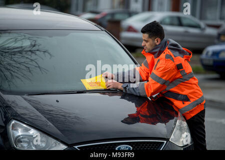 Wheel clamping of untaxed vehicles is becoming more common with the paper tax disc display being abolished and car tax needing to be paid online. Stock Photo