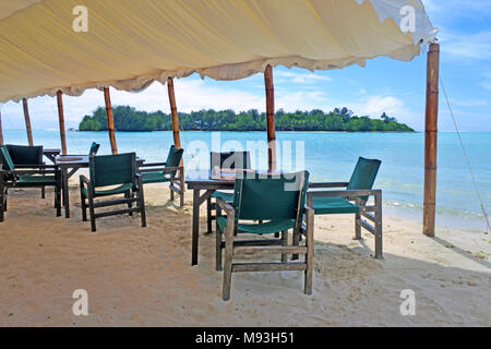 Landscape view of marquee with chairs and tables against  Koromiri islet in Muri Lagoon Rarotonga, Cook Islands.