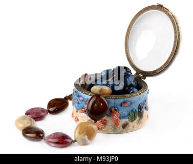 Beads of colored stones in a box on a white background. Stock Photo