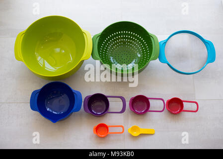 Plastic cups of a multi-colored dish in the kitchen Stock Photo