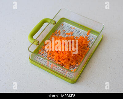 Green plastic grater. isolated on white background carrot Stock Photo