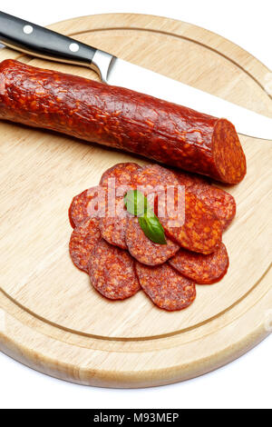 Italian Salami or spanish chorizo on plate white background Stock Photo